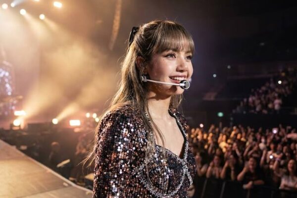 Lisa of BLACKPINK performing on a global stage, representing her international influence and worldwide popularity