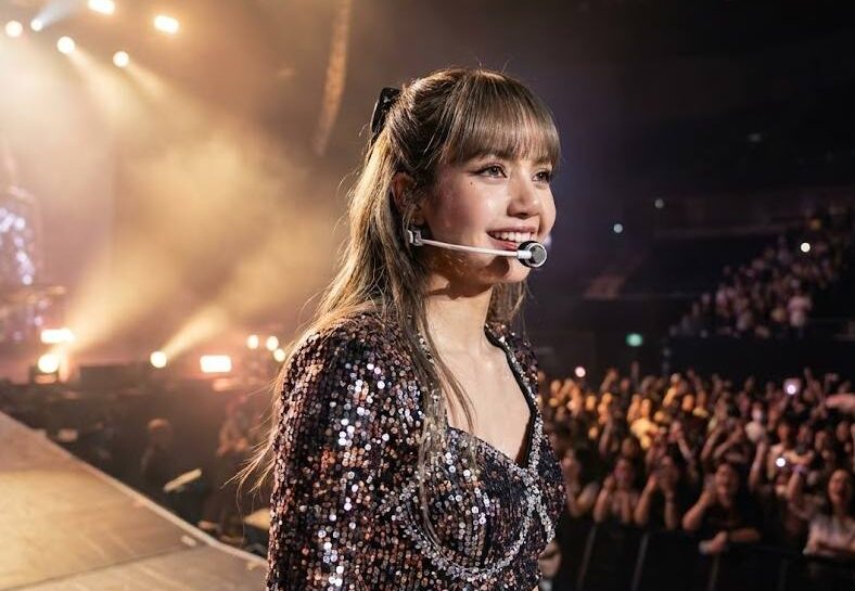 Lisa of BLACKPINK performing on a global stage, representing her international influence and worldwide popularity